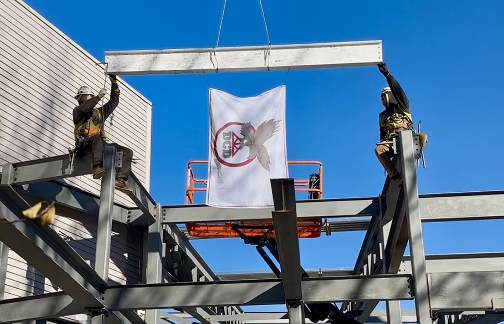 C.E. Floyd celebrates topping off milestones at two school projects