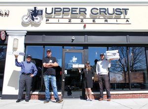 Shown (from left) are: Joel Kadis, partner – Leasing & Development of Linear Retail; Shawn Shenefield, director of operations East Coast of Upper Crust Pizzeria; Lauren Rogers, asset manager of Linear Retail; and Evan Eisenhardt, VP – Leasing of Linear Retail